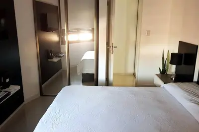a bedroom with a large white bed in a room at LOAN Nueva Cordoba 4E in Cordoba