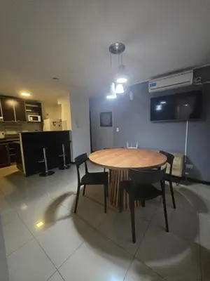 a dining room with a table and chairs and a kitchen at LOAN Nueva Cordoba 3i in Cordoba