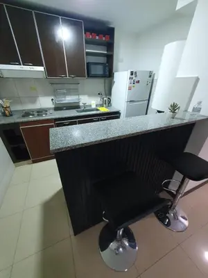 a kitchen with a counter and two bar stools at LOAN Nueva Cordoba 3i in Cordoba