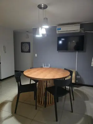 a dining room with a wooden table and chairs at LOAN Nueva Cordoba 3i in Cordoba