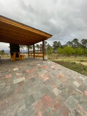 a pavilion with a wooden roof on a patio at Complejo Anthea in Villa Yacanto