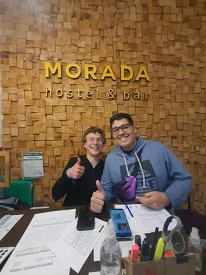 two men giving thumbs up in front of a morada museum and bar at Morada Hostel & Bar in Cordoba