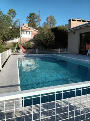 a swimming pool with blue water in a yard at Cabañas Akumali in Nono