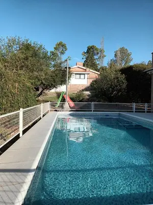 a swimming pool with a slide in a house at Cabañas Akumali in Nono