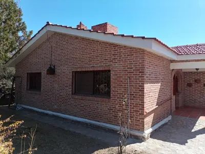a brick house with a window on the side of it at Cabañas Akumali in Nono