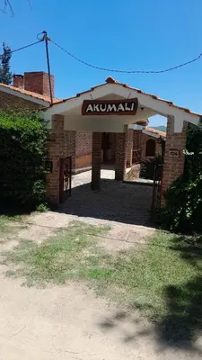 an entrance to a brick building with an akril sign at Cabañas Akumali in Nono