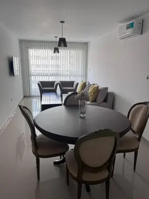a living room with a table and chairs and a couch at Dpto Nva Cba, pileta seguridad, cochera in Cordoba
