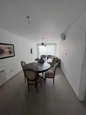 a living room with a table and chairs and a couch at Dpto Nva Cba, pileta seguridad, cochera in Cordoba
