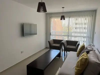 a living room with a couch and a table at Dpto Nva Cba, pileta seguridad, cochera in Cordoba