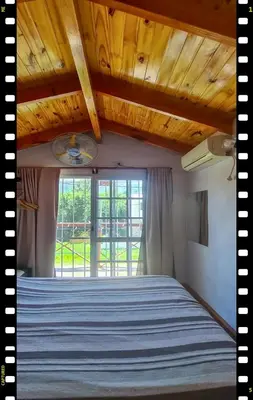 a bedroom with a bed with a wooden ceiling at Cabaña en las Sierras, Sierras Rio Sol!!! Espectacular Cabaña Frente al Rio y las Sierras in Santa María