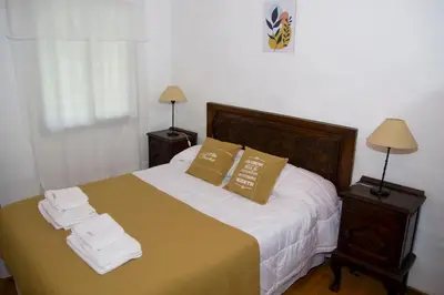 a bedroom with a bed with towels on it at Cabañas Los 2 Algarrobos in Santa Rosa de Calamuchita