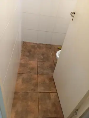 a small bathroom with a toilet in a stall at Sierras Altas Alojamientos in Villa Carlos Paz