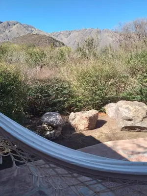 a hammock in a garden with rocks and trees at Cabaña La Raquela in La Paz