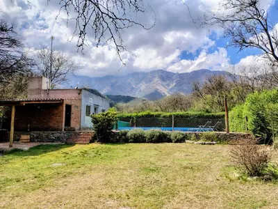 a house with a pool and mountains in the background at Cabaña La Raquela in La Paz