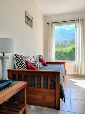 a bedroom with a bed and a large window at Cabaña La Raquela in La Paz