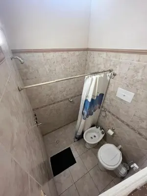 a bathroom with a shower with a toilet and a shower curtain at Apartamento Nuevo Centro in Cordoba