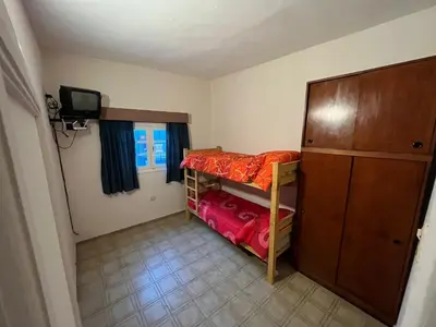 a small room with a bunk bed and a television at Apartamento Nuevo Centro in Cordoba