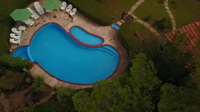 an overhead view of a swimming pool in a park at Cabañas Agua que Brilla in Mina Clavero