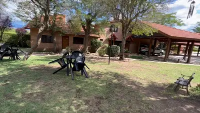 a group of sculptures in the yard of a house at Cabañas Agua que Brilla in Mina Clavero