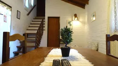 a wooden table with two remote controls on top of it at Cabañas Agua que Brilla in Mina Clavero