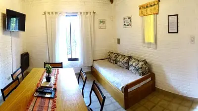 a room with a couch and a table in a room at Cabañas Agua que Brilla in Mina Clavero