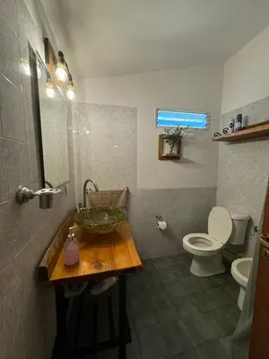 a bathroom with a sink and a toilet at Casita de Cuesta in Villa Icho Cruz