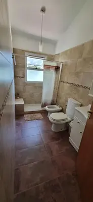 a bathroom with two toilets and a window at Casa en Villa Los Aromos in La Bolsa