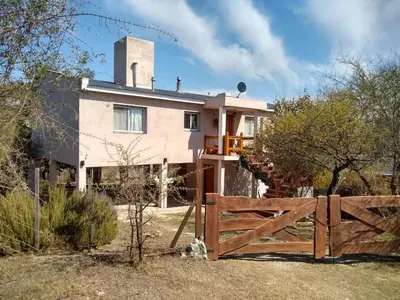 a house with a fence in front of it at Casa en Villa Los Aromos in La Bolsa
