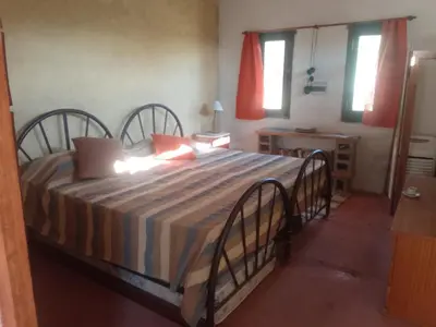 a bedroom with a large bed in a room at Chañares Majuk in San Javier