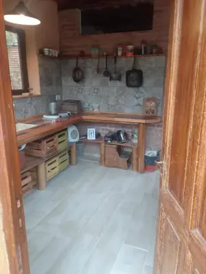 a kitchen with a wooden table in a room at Chañares Majuk in San Javier
