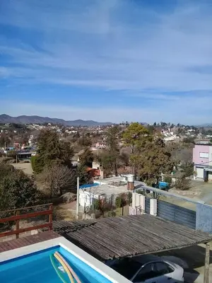 a swimming pool on the roof of a house at CABAÑAS BALCON DE PEHUMAYEN in Villa Carlos Paz