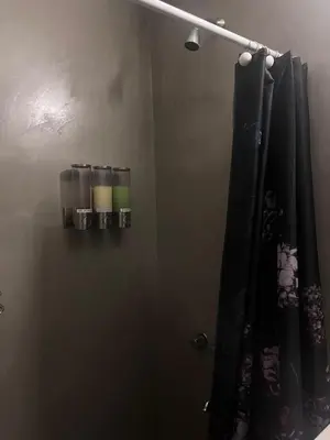 a bathroom with a shower curtain and a mirror at Apartamento El Colibri in Cordoba
