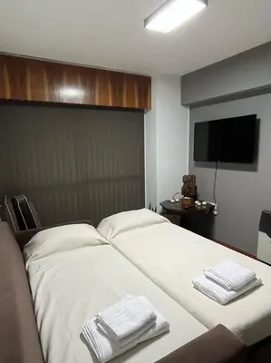 a hotel room with a bed with towels on it at Apartamento El Colibri in Cordoba