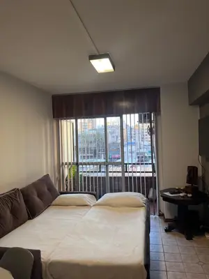 a bedroom with a bed and a couch and a window at Apartamento El Colibri in Cordoba