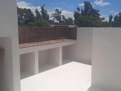 a white building with a bench on top of it at COMPLEJO CRUZ in Alta Gracia
