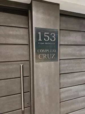 a metal door with a sign on it at COMPLEJO CRUZ in Alta Gracia