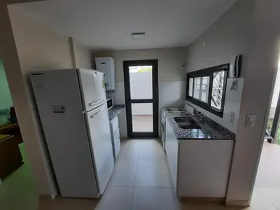 a kitchen with a refrigerator and a sink in it at COMPLEJO CRUZ in Alta Gracia