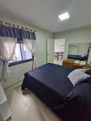 a bedroom with a bed and a window and a table at COMPLEJO CRUZ in Alta Gracia