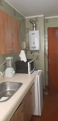 a kitchen with a sink and a microwave at Mi depto en Córdoba II . in Cordoba