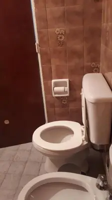 a bathroom with a white toilet in a room at Mi depto en Córdoba II . in Cordoba