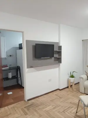 a living room with a tv on a white wall at Mi depto en Córdoba II . in Cordoba