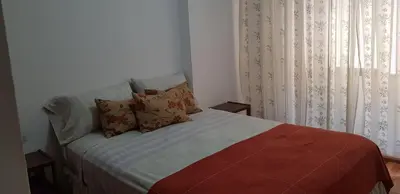 a bedroom with a bed with pillows and a window at Mi depto en Córdoba II . in Cordoba