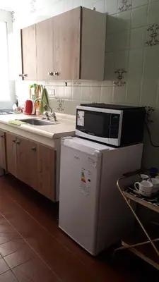 a kitchen with a microwave on top of a refrigerator at Mi depto en Córdoba II . in Cordoba