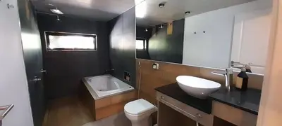 a bathroom with a white sink and a toilet at Laurentino Loft & Home in Villa General Belgrano