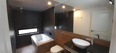 a bathroom with a sink and a toilet and a mirror at Laurentino Loft & Home in Villa General Belgrano