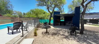 a backyard with a fence and a swimming pool at Laurentino Loft & Home in Villa General Belgrano