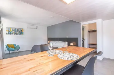 a dining room with a wooden table and chairs at Laurentino Loft & Home in Villa General Belgrano