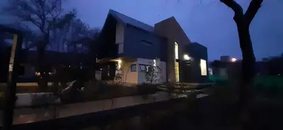 a house with lights on in front of it at Laurentino Loft & Home in Villa General Belgrano