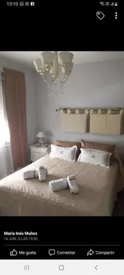 a bedroom with a bed with two towels on it at MM Apart in Río Cuarto
