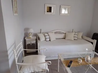 a white bedroom with a bed and a table at MM Apart in Río Cuarto